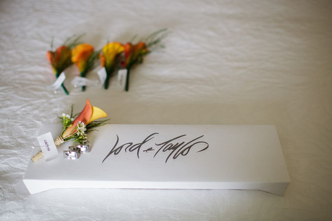 Boutonnieres beside a calligraphed box