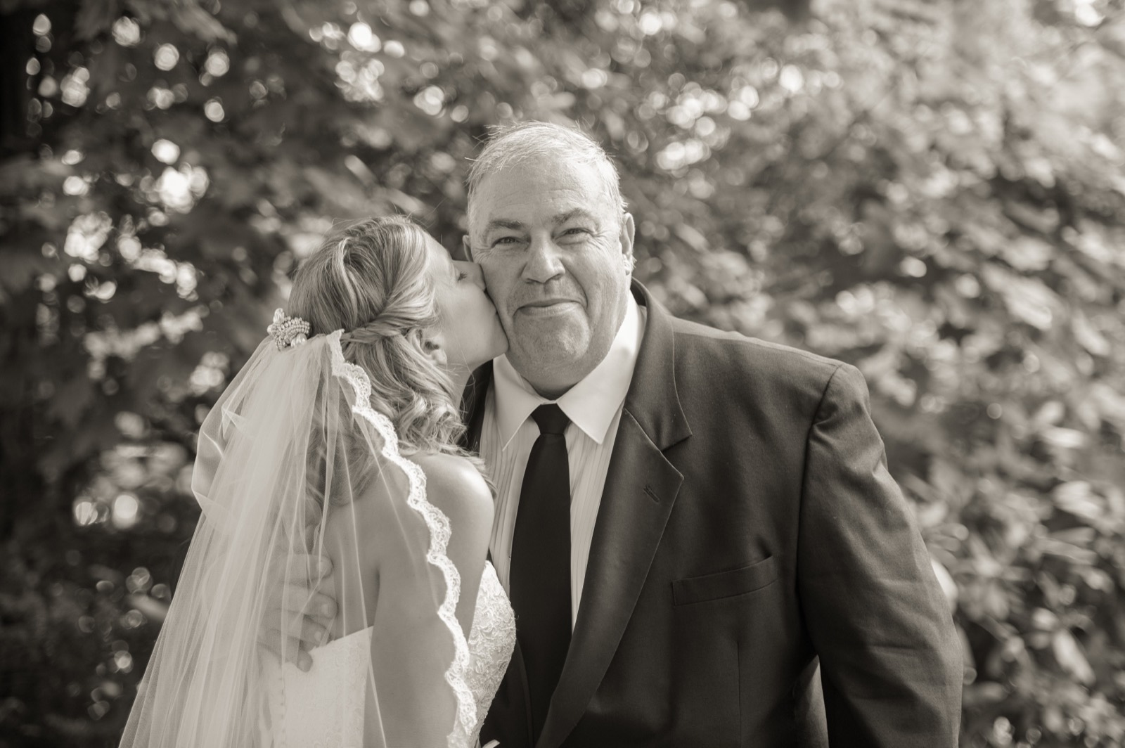 Devin kissing her dad on the cheek on the wedding day