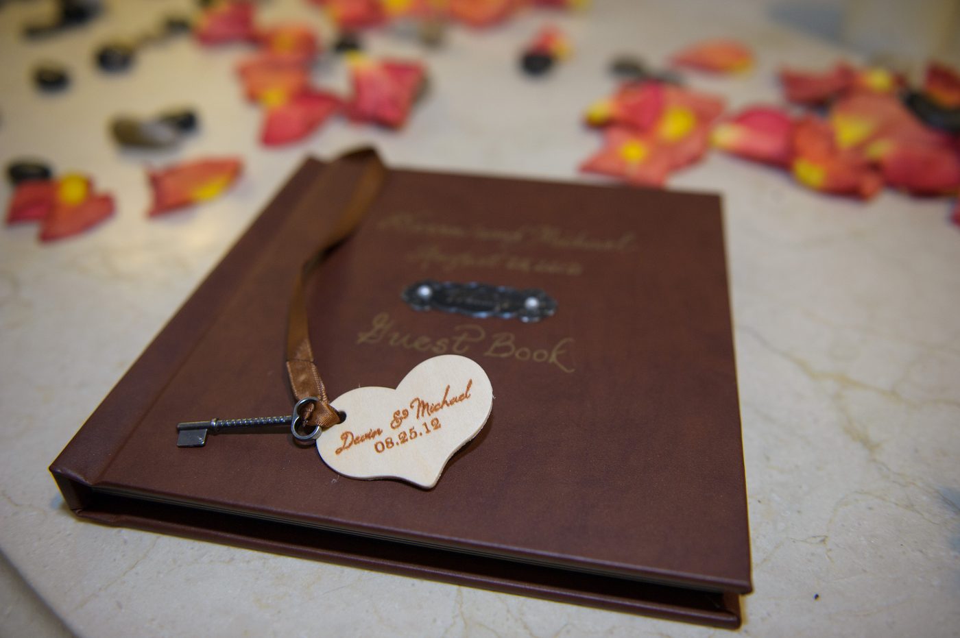 The leather guest book with wood heart and key