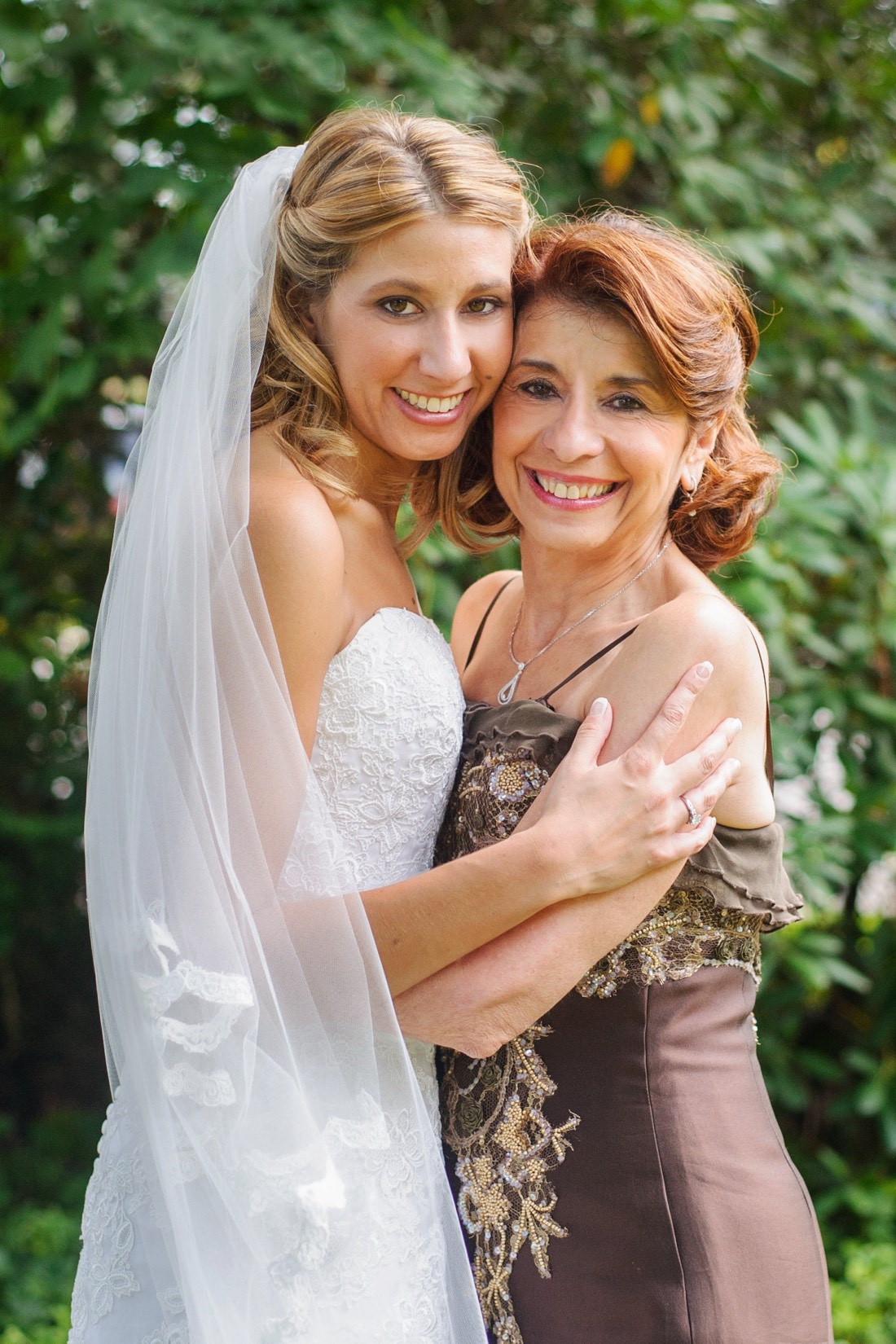 Devin and her mom, arms around each other, on the wedding day